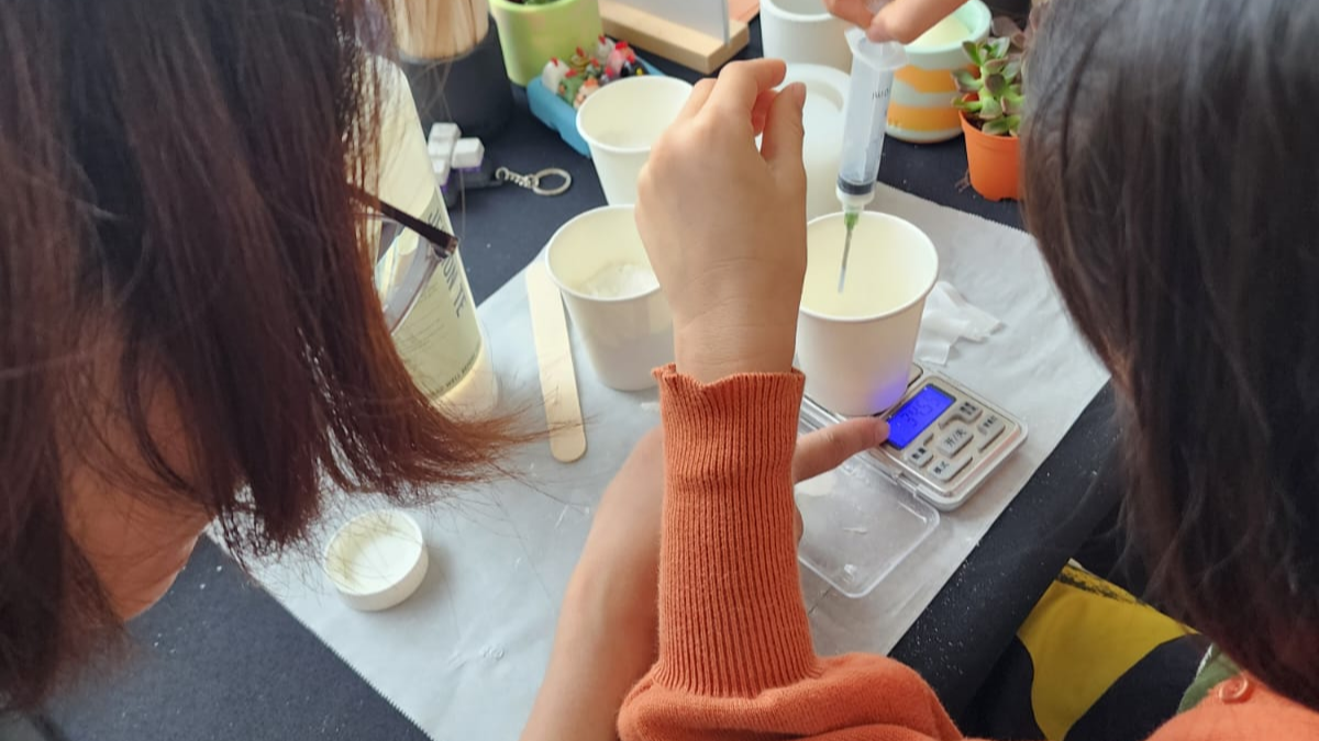 Facilitator guiding child through a fun, interactive crafting experience at Meet & Make Popup